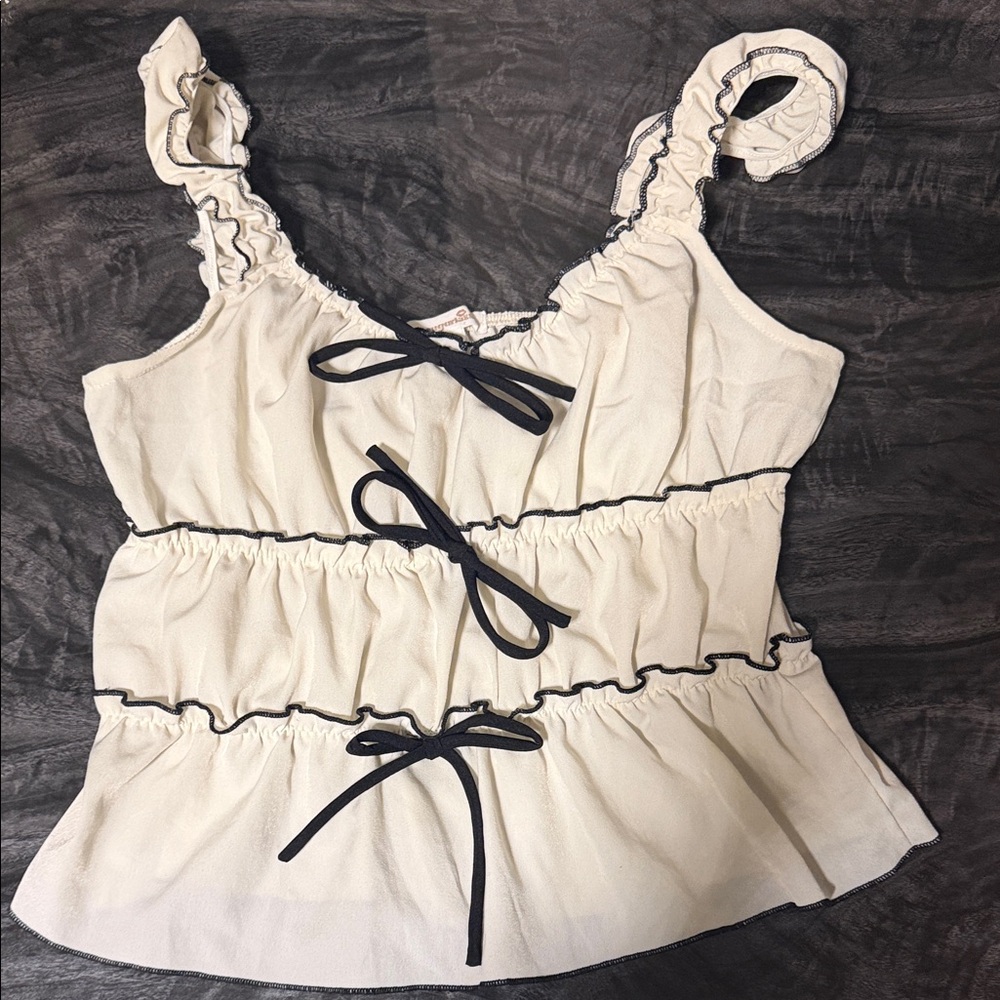 Chic Cream Ruffle Blouse with Black Trim